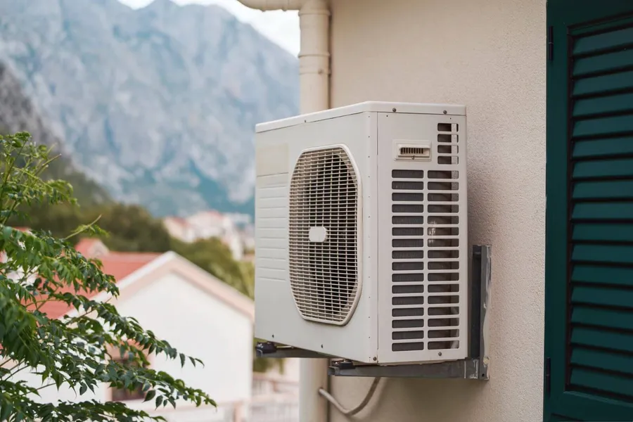AC outdoor units mounted on a residential building exterior in France