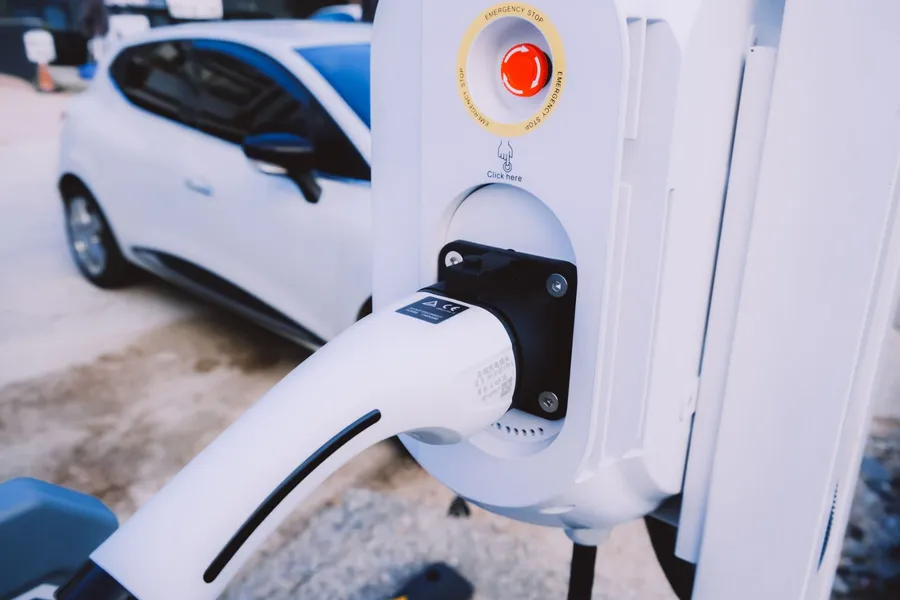 EV charging connector plugged into a wallbox charger at a residential property