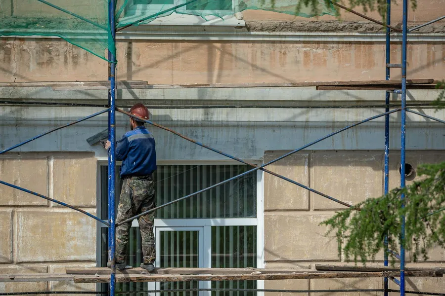 Scaffolding against a rendered facade during renovation on the French Riviera