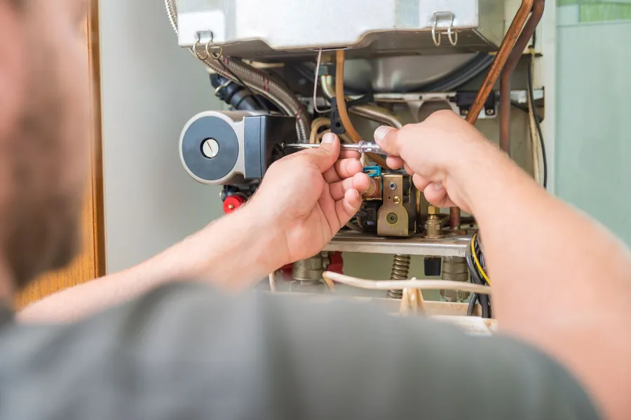 Technician carrying out maintenance on a residential gas boiler