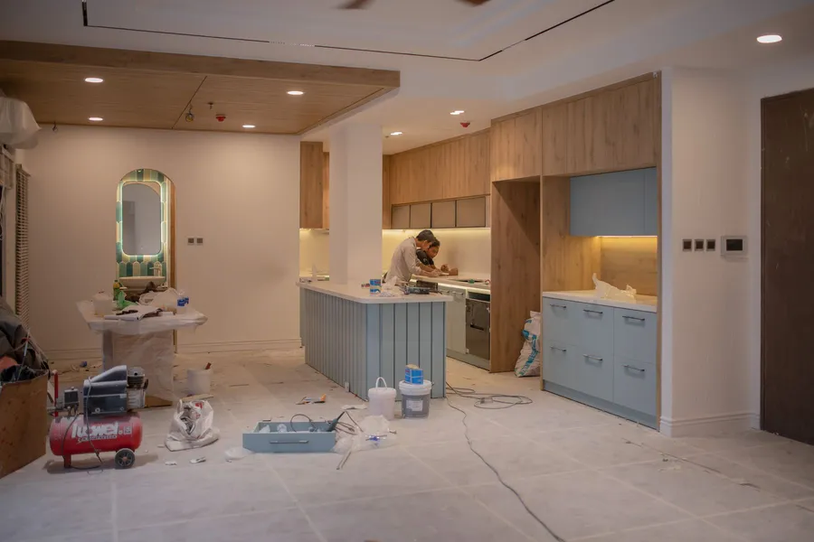 Kitchen renovation in progress with units removed and walls exposed